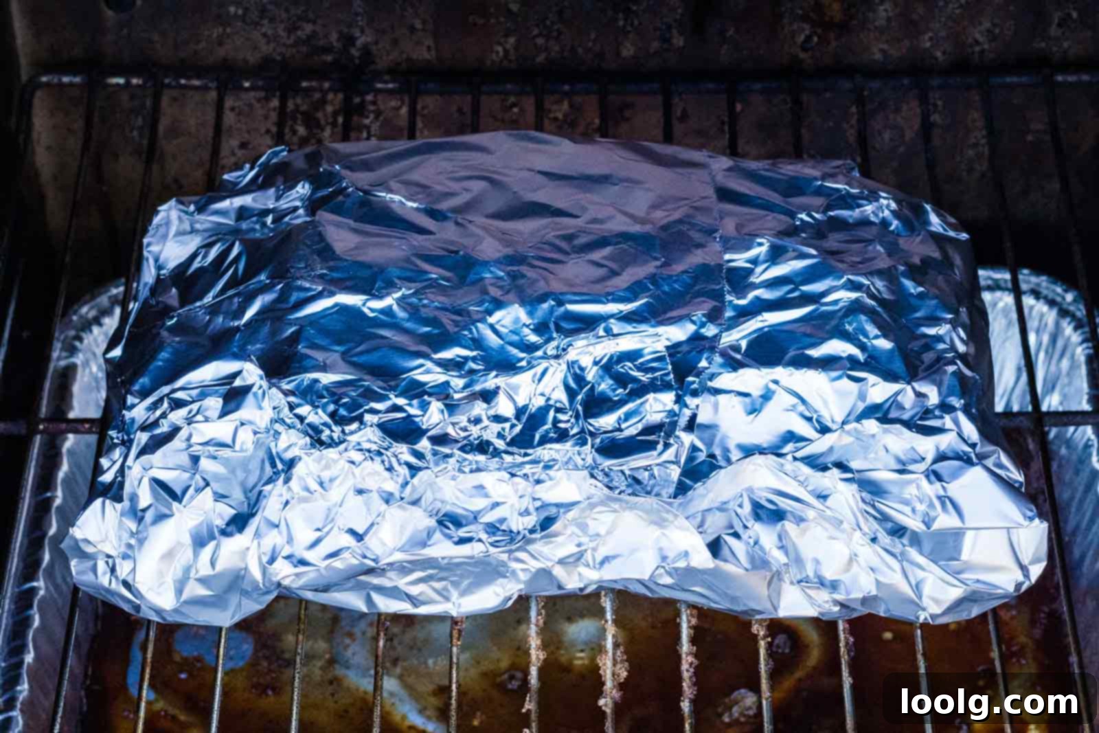 Slow-Smoked Corned Brisket 8 brisket wrapped in foil on the smoker grate