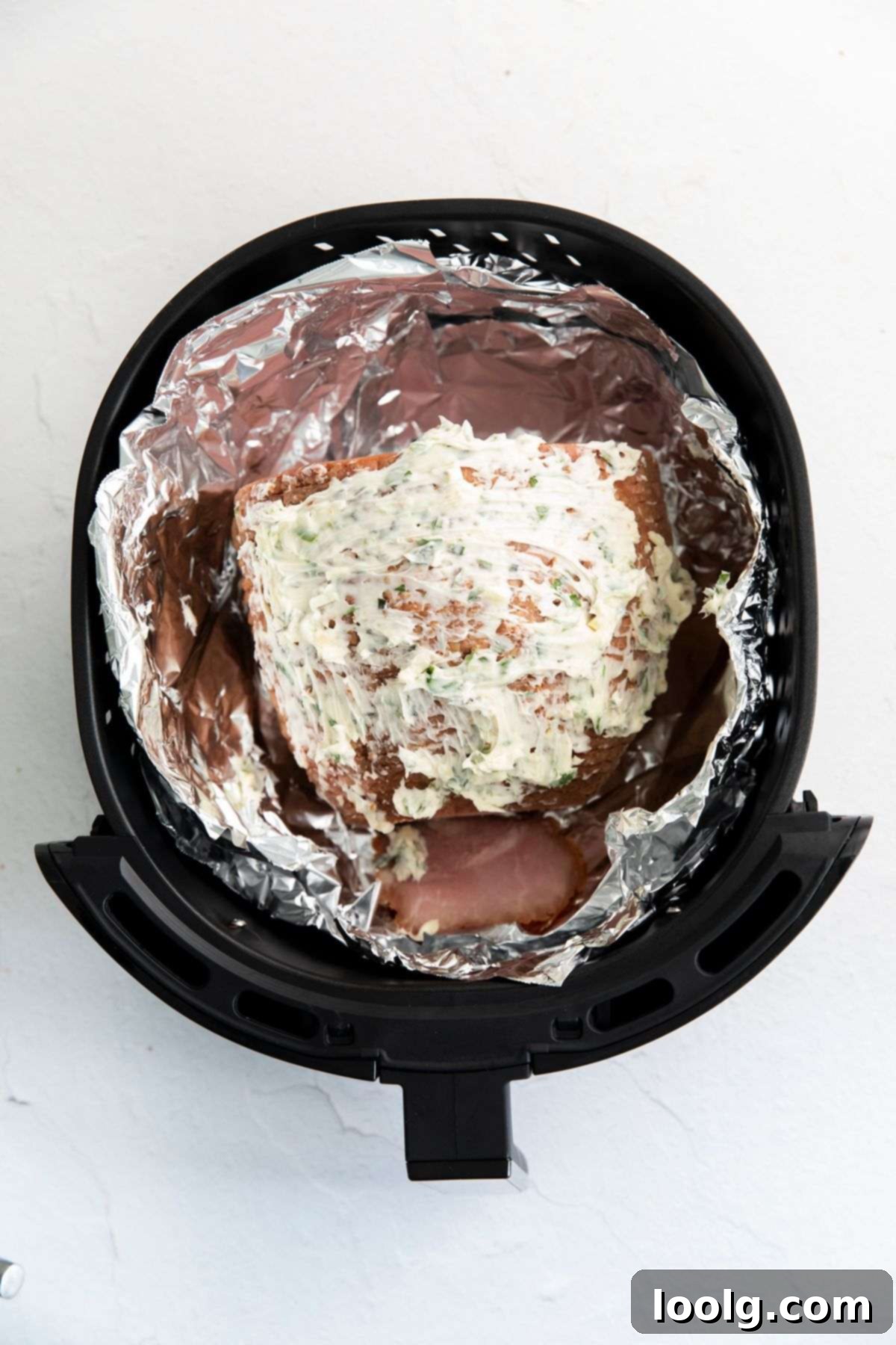 Crispy Golden Air Fryer Ham 5 ham in air fryer with butter on top