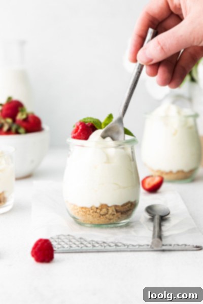 Creamy Cheesecake Mousse 4 A spoon scooping into a serving of creamy cheesecake mousse with berry topping