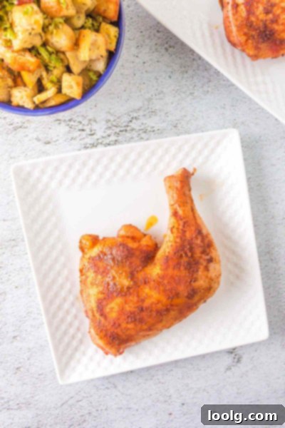 Perfectly Smoked Chicken Quarters 2 Perfectly smoked chicken leg quarter with a savory dry rub, looking tender and juicy on a serving plate.