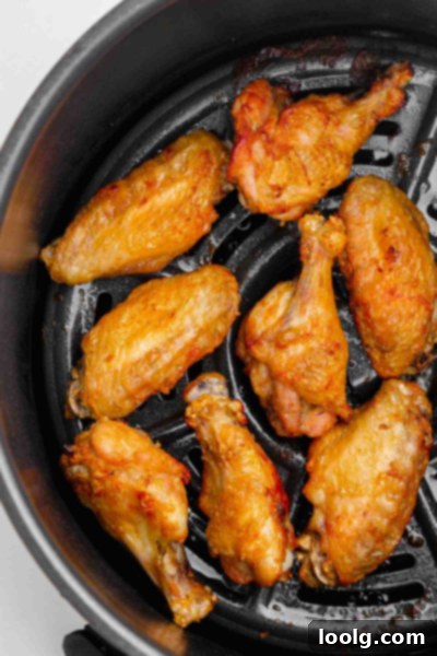 Frozen to Fabulous Air Fryer Chicken Wings 6 cooked wings inside air fryer basket