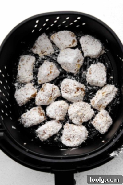 Crispy Air Fryer Teriyaki Chicken 4 coated chicken chunks in air fryer basket