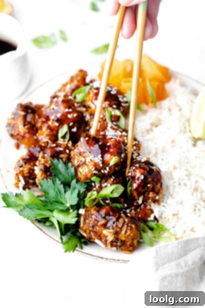 Crispy Air Fryer Teriyaki Chicken 10 chopsticks picking up teriyaki chicken