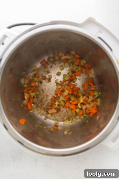 Speedy & Satisfying Tortellini Soup 4 Diced vegetables like carrots, celery, and onions being sautéed in an Instant Pot