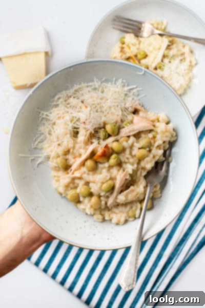Creamy Chicken and Pea Risotto 14 Creamy chicken and pea risotto garnished with fresh herbs in a serving bowl