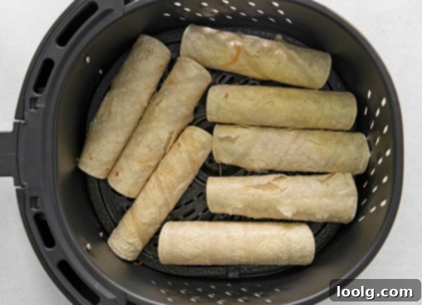 Air-Fried Taquito Perfection 6 Air Fryer Taquitos with various toppings like lettuce, avocado, and sour cream