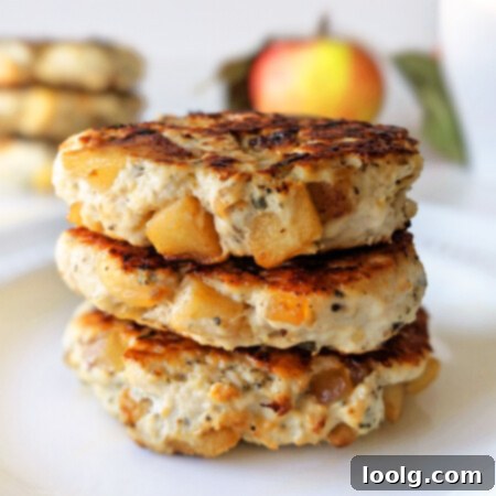 Sweet and Savory Chicken Apple Sausage 5 Final cooked chicken apple sausage patties on a white plate with fresh sage.