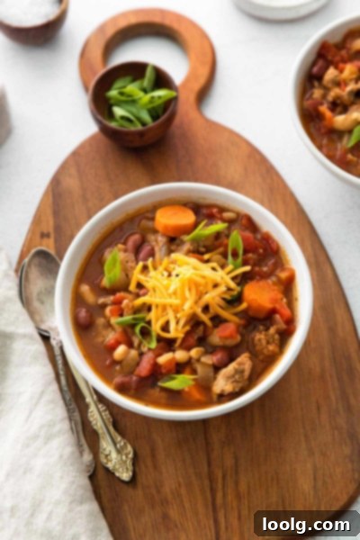 The Ultimate Instant Pot Turkey Chili 2 A bowl of Instant Pot Turkey Chili, garnished with fresh herbs and a spoon, ready to be served.