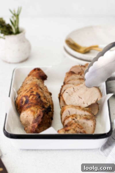 Perfect Air Fryer Pork Tenderloin 6 Air Fryer Pork Tenderloin on a white plate with roasted vegetables