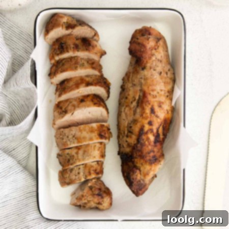 Perfect Air Fryer Pork Tenderloin 7 Top view of two cooked air fryer pork tenderloins one cut into slices and the other whole in a white serving dish
