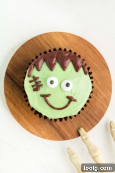 Frankenstein cupcakes on a wooden cutting board