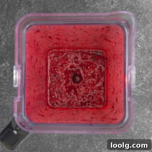 Fright Night Fizz 4 A close-up of the non-alcoholic Halloween punch, showing the vibrant red liquid and hints of garnishes.