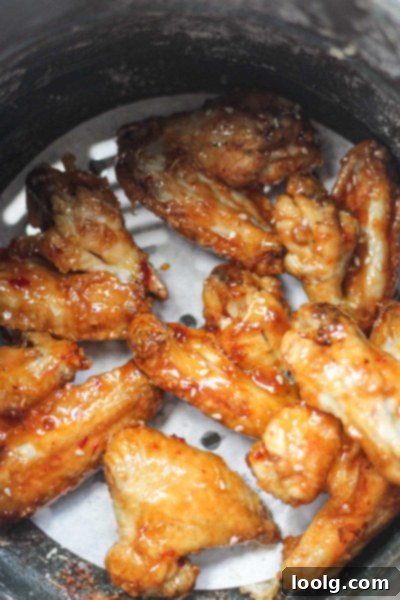 Baked or Air Fried Honey Garlic Wings 8 A large platter of cooked honey garlic chicken wings, perfectly browned and glazed, garnished with herbs