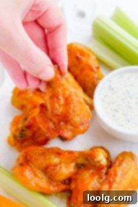 Your Air Fryer Game Day Playbook 2 Hand picking up crispy air fryer chicken wings
