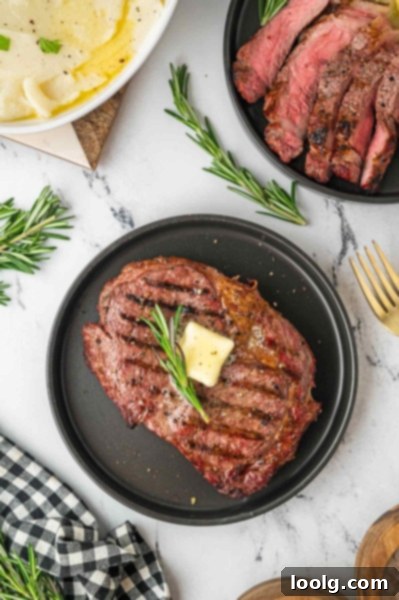 Ultimate Smoked Ribeye 9 A smoker in action, with smoke gently rising, highlighting the process of infusing food with rich, smoky flavors.