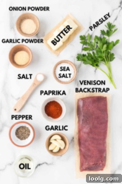 Prime Venison Loin 3 A selection of fresh ingredients laid out on a kitchen counter, including venison backstrap, herbs, garlic, and spices, emphasizing the simplicity and freshness of the recipe.