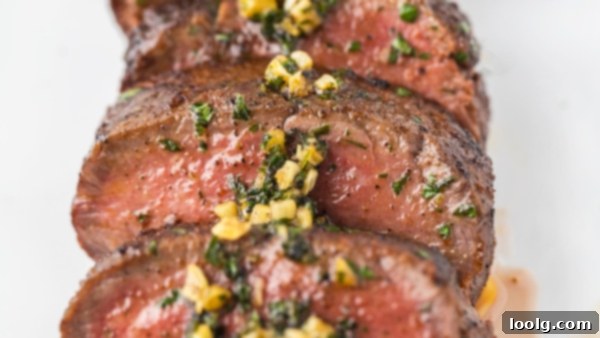 Prime Venison Loin 7 A close-up of venison backstrap generously coated with a savory spice rub, highlighting the texture and color of the seasoning.