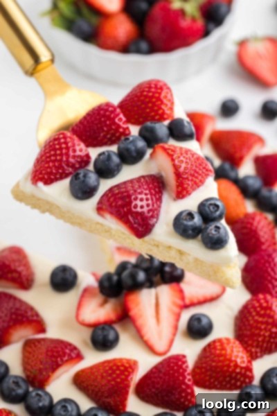 Patriotic Fruit Pizza 11 Sugar cookie dough being pressed into a pizza pan