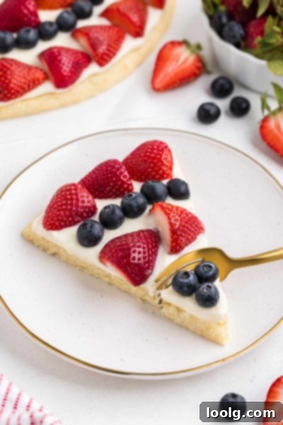 Patriotic Fruit Pizza 3 Creamy cheesecake topping spread on a sugar cookie crust