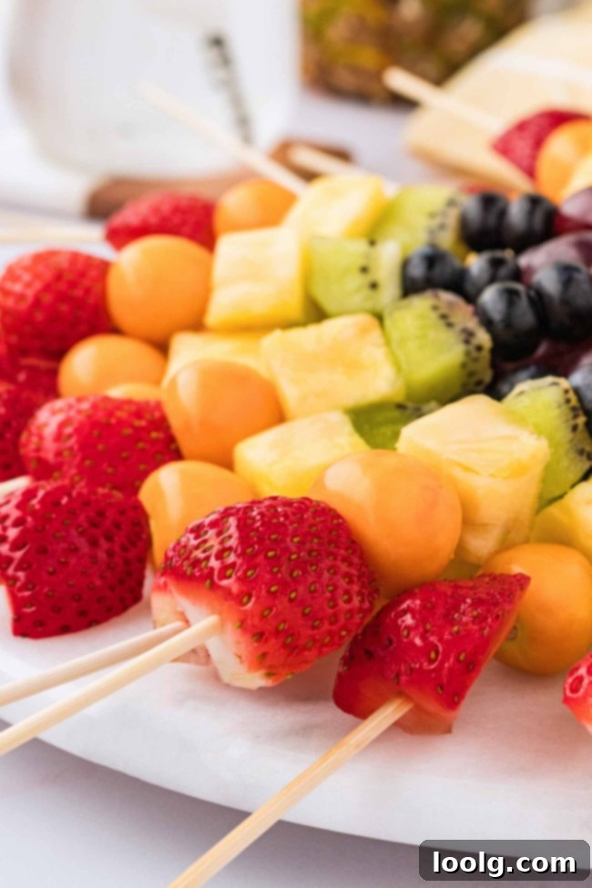 Rainbow Fruit Pops 9 A platter of rainbow fruit skewers and dip from an overhead view, highlighting the array of colors and the inviting presentation.