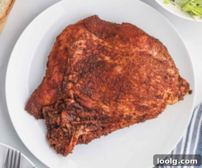 Artisan Smoked Turkey Breast 7 A cutting board with a knife and carved slices of smoked turkey breast, demonstrating the tender texture.