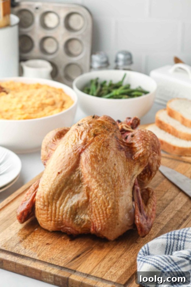 Traeger's Signature Smoked Turkey 2 A beautifully smoked whole turkey on a wooden cutting board, ready to be carved, with a vibrant green garnish.