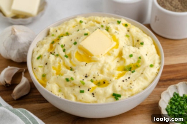 Golden Velvety Yukon Gold Mash 8 A close-up shot of creamy mashed potatoes with a swirl, possibly for serving.