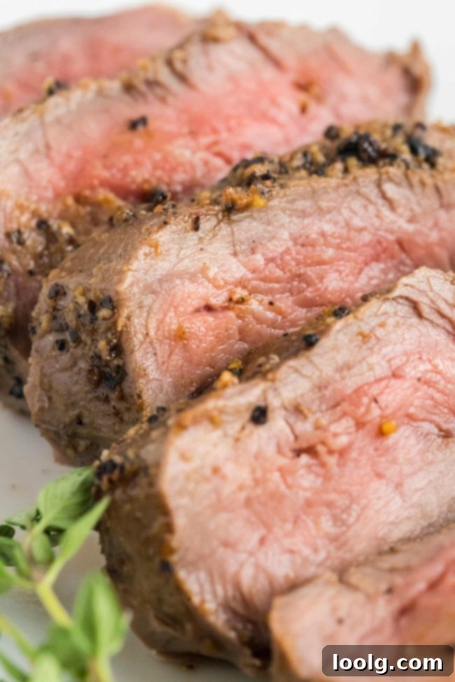 Wild Venison Tenderloin 7 A thermometer inserted into a cooked venison tenderloin to check internal temperature