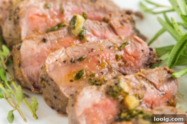 Wild Venison Tenderloin 9 The herb garlic butter sauce being drizzled over venison medallions