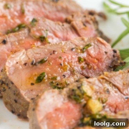 Wild Venison Tenderloin 10 Image of a juicy venison tenderloin topped with a garlic herbed butter that looks irresistible.