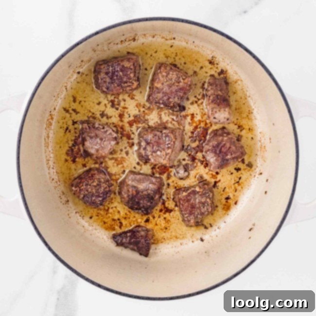 Hearty Venison Stew 8 Step 3: Browning venison on all sides in a Dutch oven.
