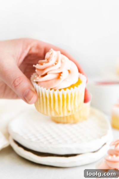 Spring Rhubarb Delights 2 rhubarb cupcake being held up