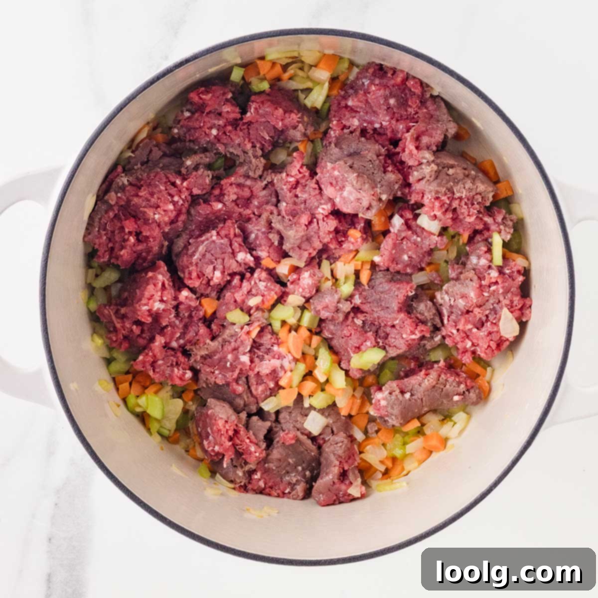 Slow-Simmered Venison Bolognese 6 adding ground venison into the pan with cooked onions