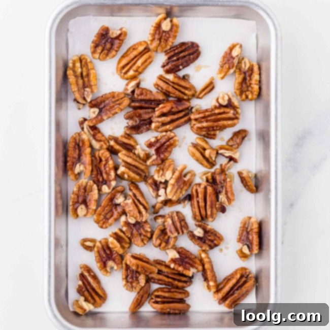 Artisan Goat Cheese Salad 5 honey roasted pecans spread out on a baking sheet