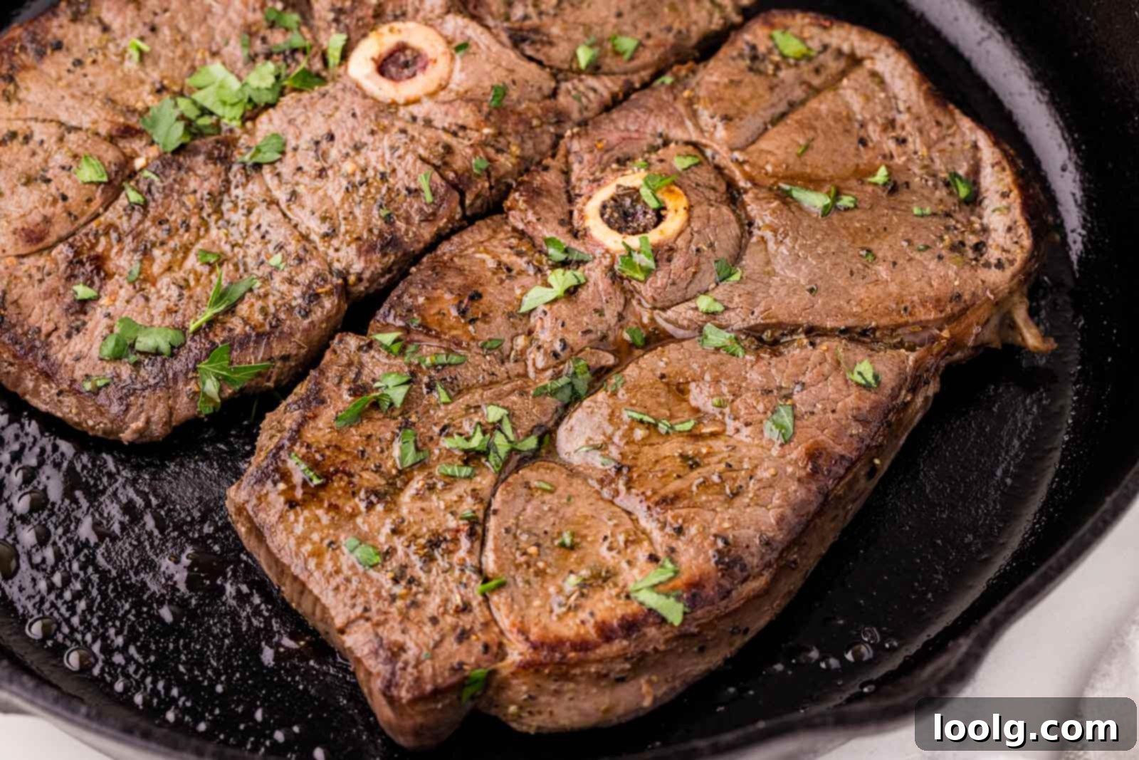 Signature Venison Steaks 5 2 venison steaks in a cast-iron skillet