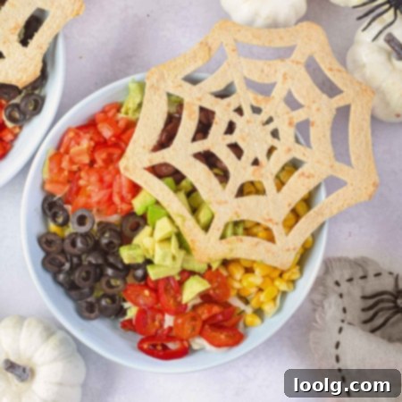 Spooky Taco Bowls 3 halloween taco salad with spider tortilla in a white bowl