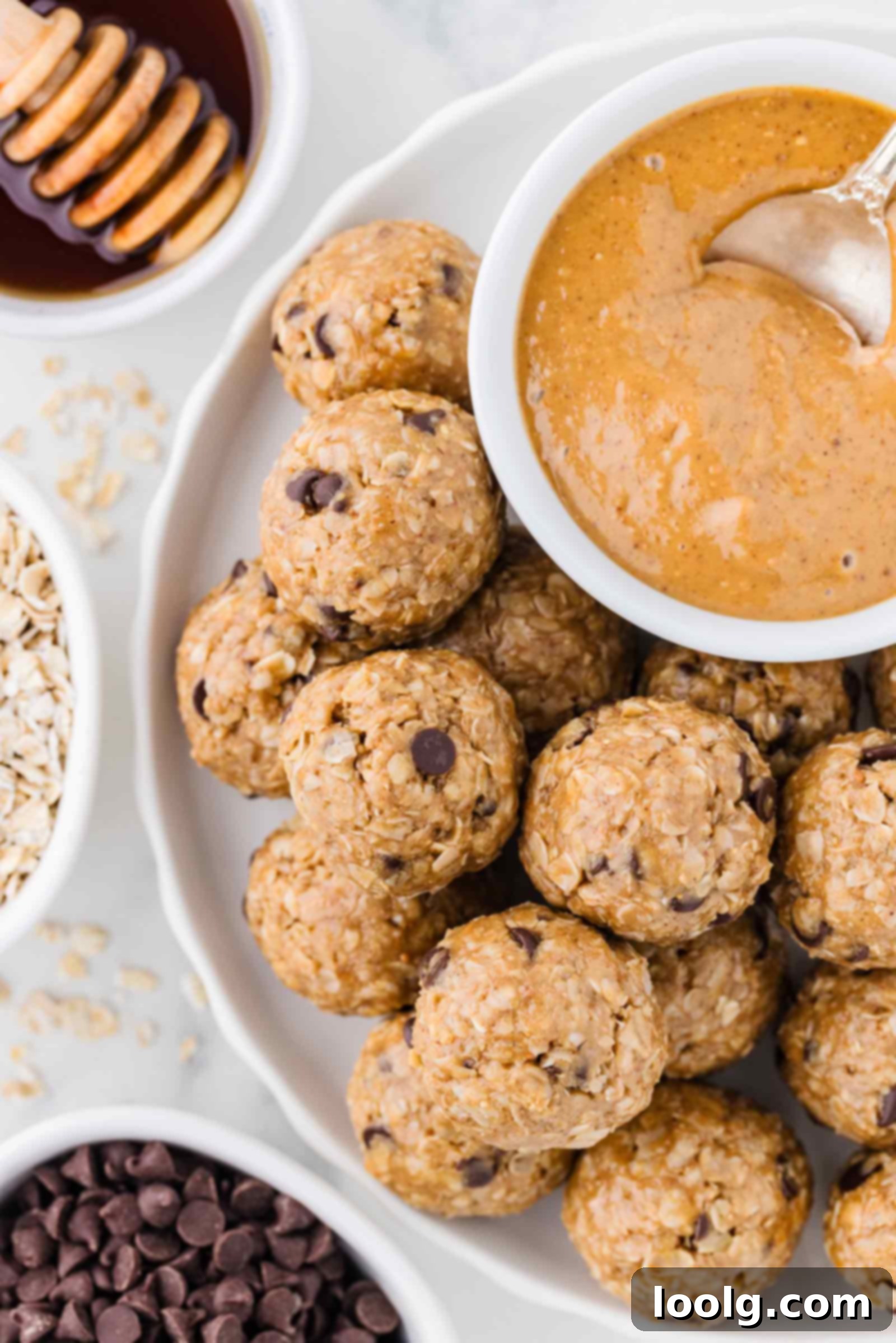 No-Bake Peanut Butter Oatmeal Energy Bites 7 oat and peanut butter balls on white plate with peanut butter