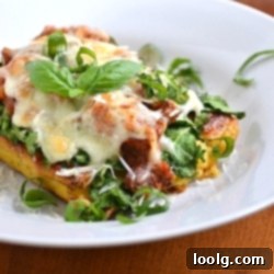 Golden Polenta Stack 1 image of polenta lasagna garnished with fresh basil