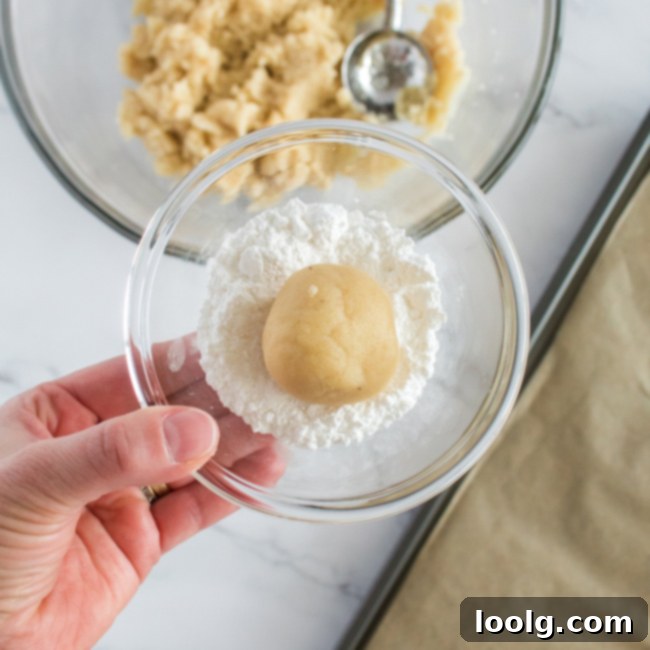 Almond Amore Bites 8 Ball of cookie dough generously coated in powdered sugar in a bowl