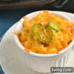 Butternut Heat Mac & Cheese 1 Jalapeno Butternut Mac and Cheese in a white bowl with a spoon