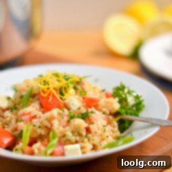 Greek Brown Rice Bake 1 Baked Greek Brown Rice in a bowl with a fork for serving