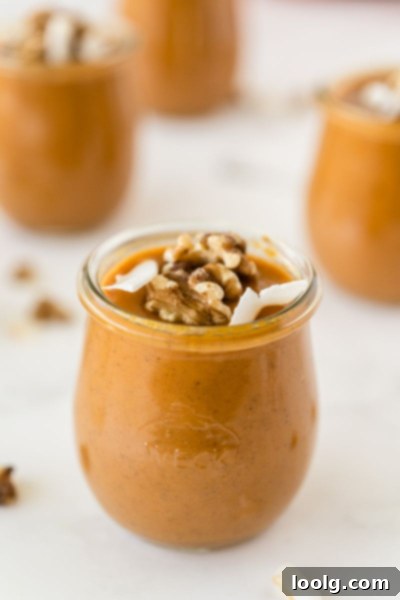 Velvet Pumpkin Dream 5 close-up photo of honey pumpkin pudding in a glass jar, garnished with toasted walnuts