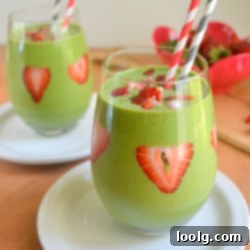 Vibrant Strawberry Green Blend 3 Strawberry Green Smoothie with a creamy texture, garnished with fresh fruit, in a stylish glass, ideal for a healthy and quick meal.