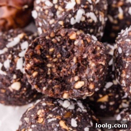 Close-up of a stack of chocolate coconut nut balls on a white plate
