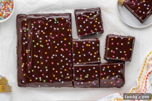 Full pan of fudgy brownies with chocolate ganache and sprinkles on top
