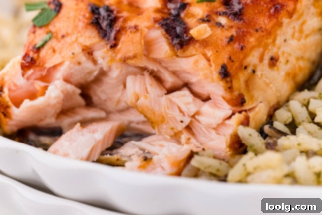 Grilled Salmon Perfection 3 Close-up view of flaky and tender barbequed salmon, highlighting its succulent texture and crispy edges.