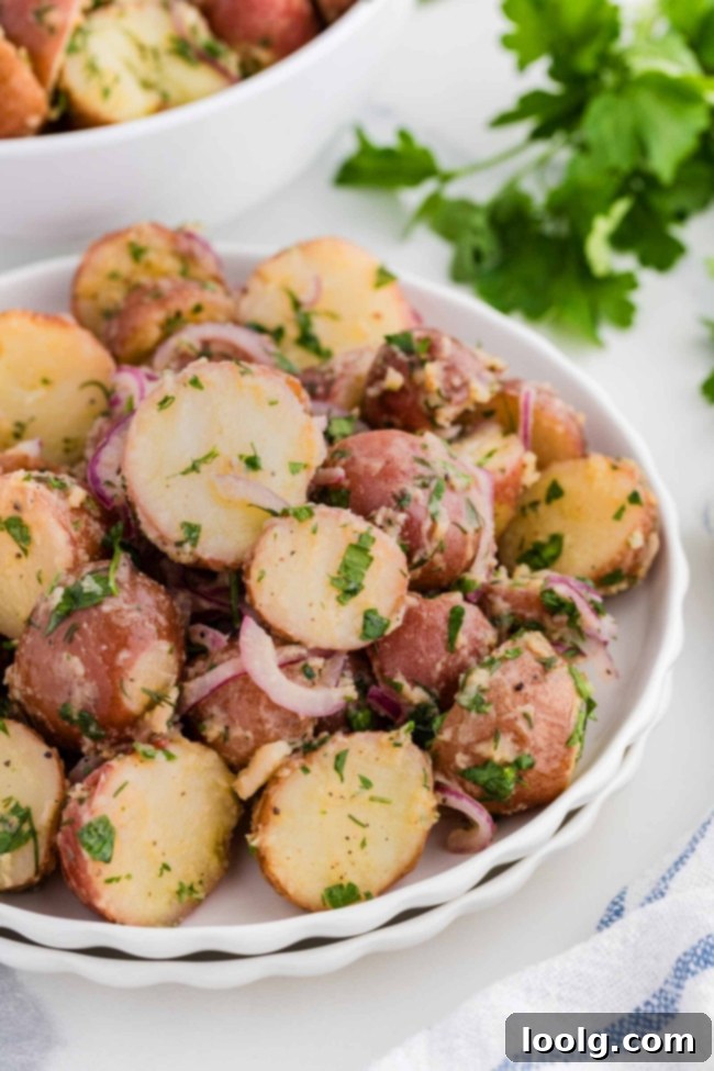 white bowl filled with no mayo potato salad with more in background