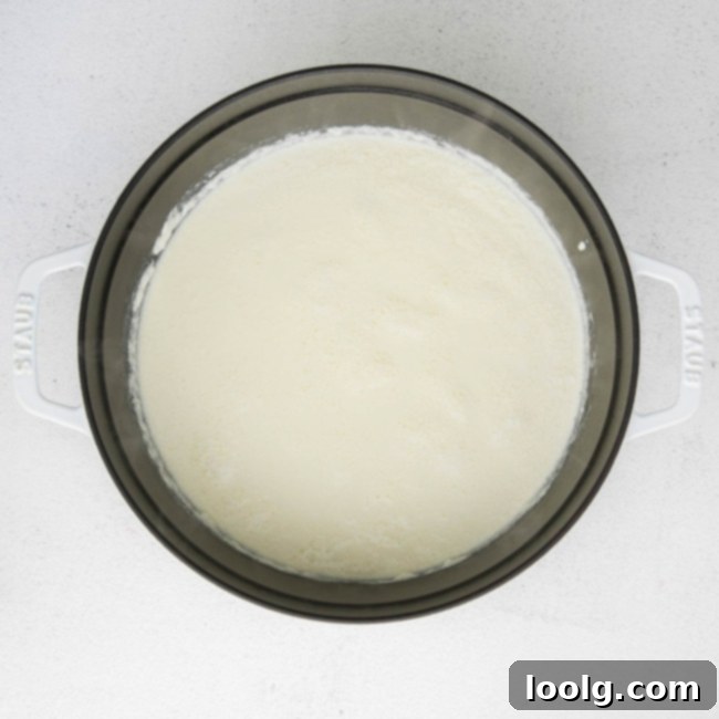 All ricotta cheese ingredients mixed together in a saucepan, beginning to curdle