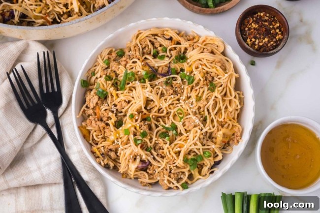 Sticky Honey Garlic Noodles with Sesame and Scallions 5 white bowl filled with honey garlic noodles on a white table with a fork on the side