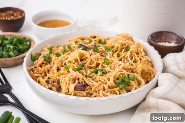 Sticky Honey Garlic Noodles with Sesame and Scallions 7 white bowl on white table filled with honey garlic noodles